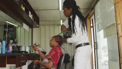 african man adding hair extensions