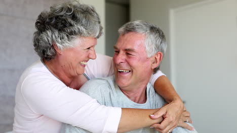 Mature-couple-laughing-and-embracing-together