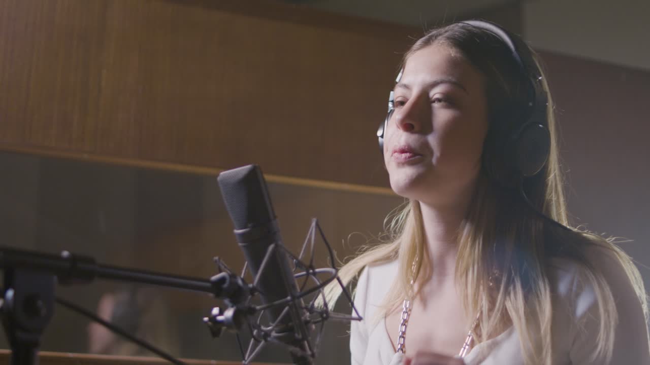 Bella cantante al lavoro in uno studio musicale.