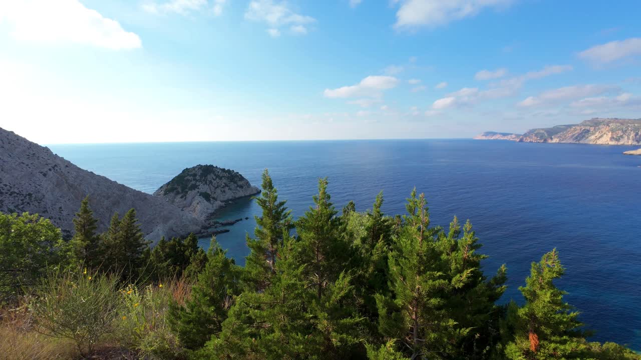 View over looking a secluded bay and beach in Kefalonia Greece blue waters and rugged mountainscapes