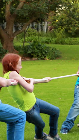 cute pupils having a tug of war