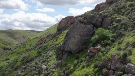 Aerial-view-of-a-rocky-area-covered-with-green-grass