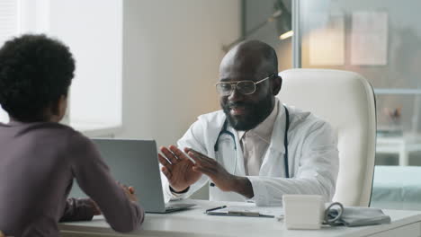 African-American-Pediatrician-Speaking-with-Boy-and-His-Mother-in-Clinic