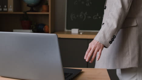 Teacher explaining mathematics on a blackboard