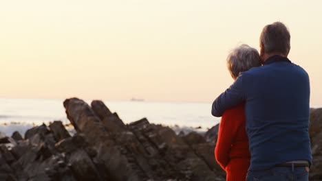 Senior-couple-embracing-on-beach-4k