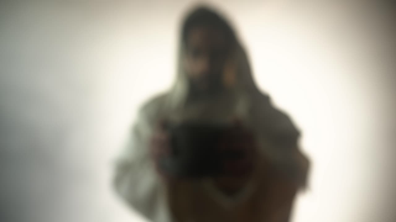 Jesus Christ in bright light, mist and fog, holding a clay jar of wine in slow motion, for a symbolic representation of the last supper, communion, sacraments, and the gospel.
