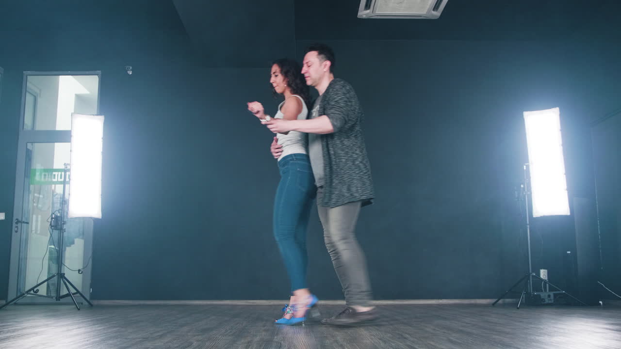 Couple dancing in studio