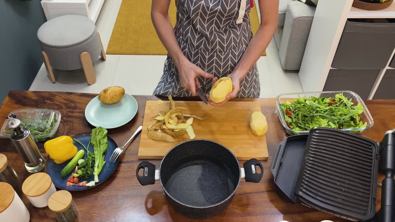 Preparing potatoes and salad for cooking