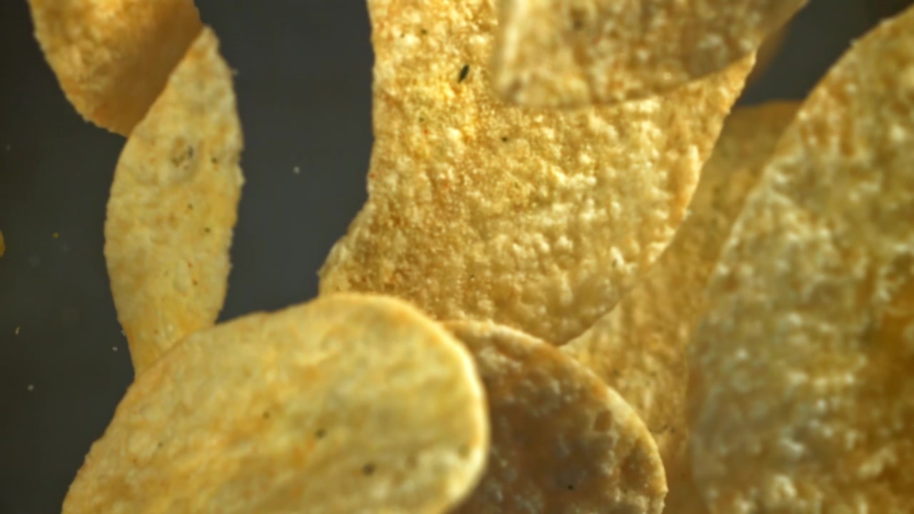 Macro Shot of Crispy Potato Chips Coming into Focus