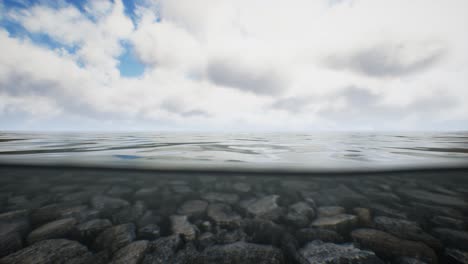 ocean seascape with sky and ocean wave splitted by waterline to underwater part