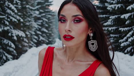 woman in a red dress in a snowy forest