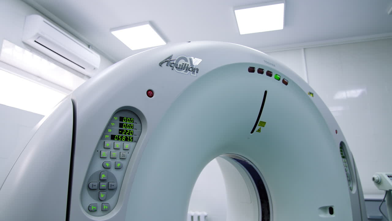 CT scan in the empty hospital room. Gradual distancing from a modern technological tomography equipment. Low angle view.