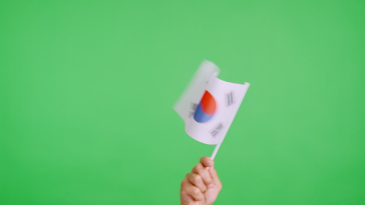 Hand waving a pennant of a south korean national flag