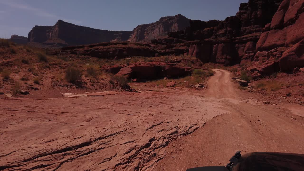 Driving on a Dirt Road Through a Red Rock Canyon