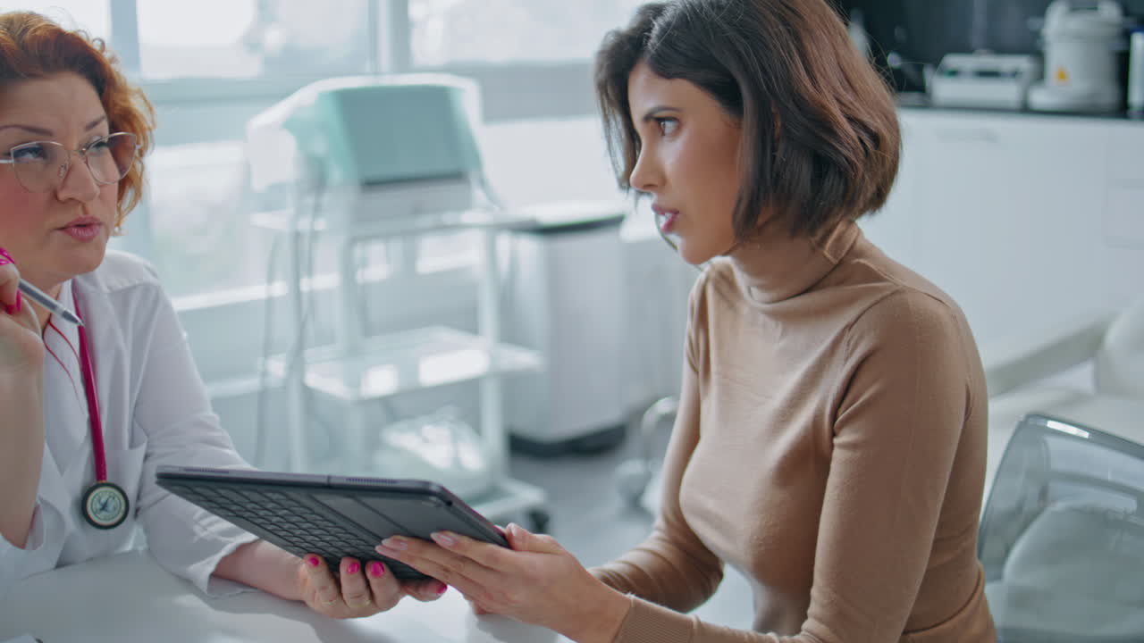 Woman Consulting with Doctor in Clinic