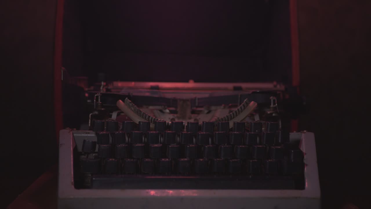 Vintage Typewriter in the Dark Illuminated by White and Red Lights