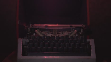 vintage typewriter in the dark illuminated by white and red lights