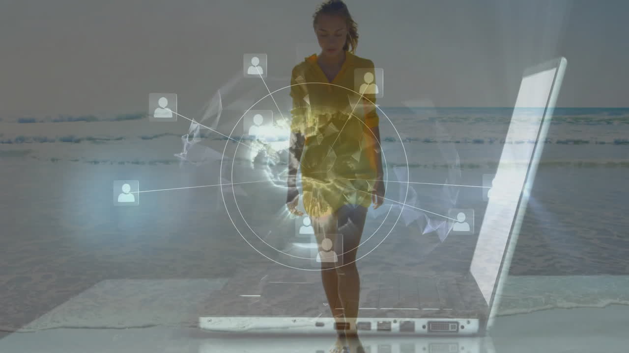 Walking on beach, woman using laptop with digital network animation overlay