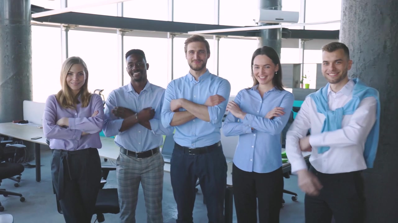 Diverse Business Team Standing and Smiling in Modern Office