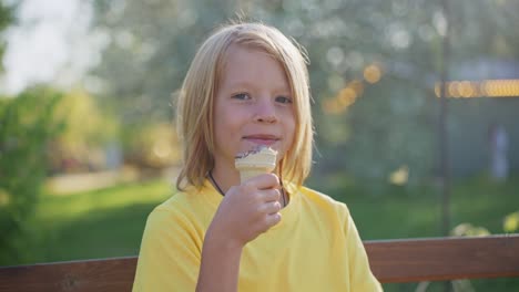 boy eating ice cream in a park