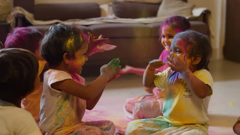 children playing with colorful powder during holi festival indoors
