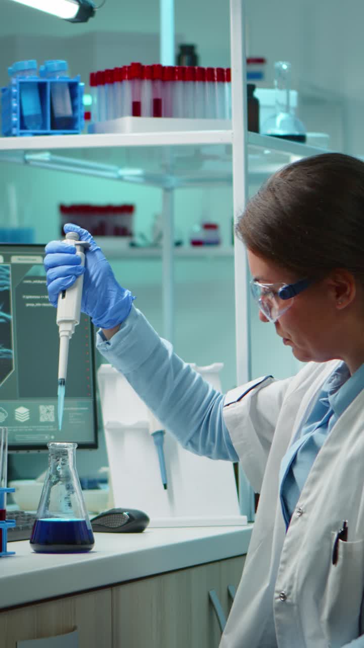 Vertical video: Scientist woman pipetting liquid to test tube