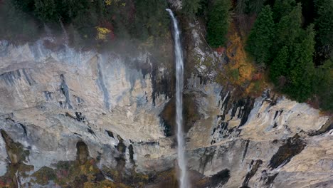 amazing waterfall over the mountain rocks falling down on a bright day in lauterbrunnen, switzerland. aerial footage