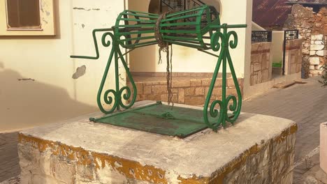 historic green fountain in old chersonissos town, crete island, greece