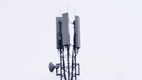 mid shot of telecommunications tower with cloudy background