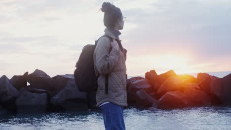 woman enjoying a beautiful sunrise at the beach