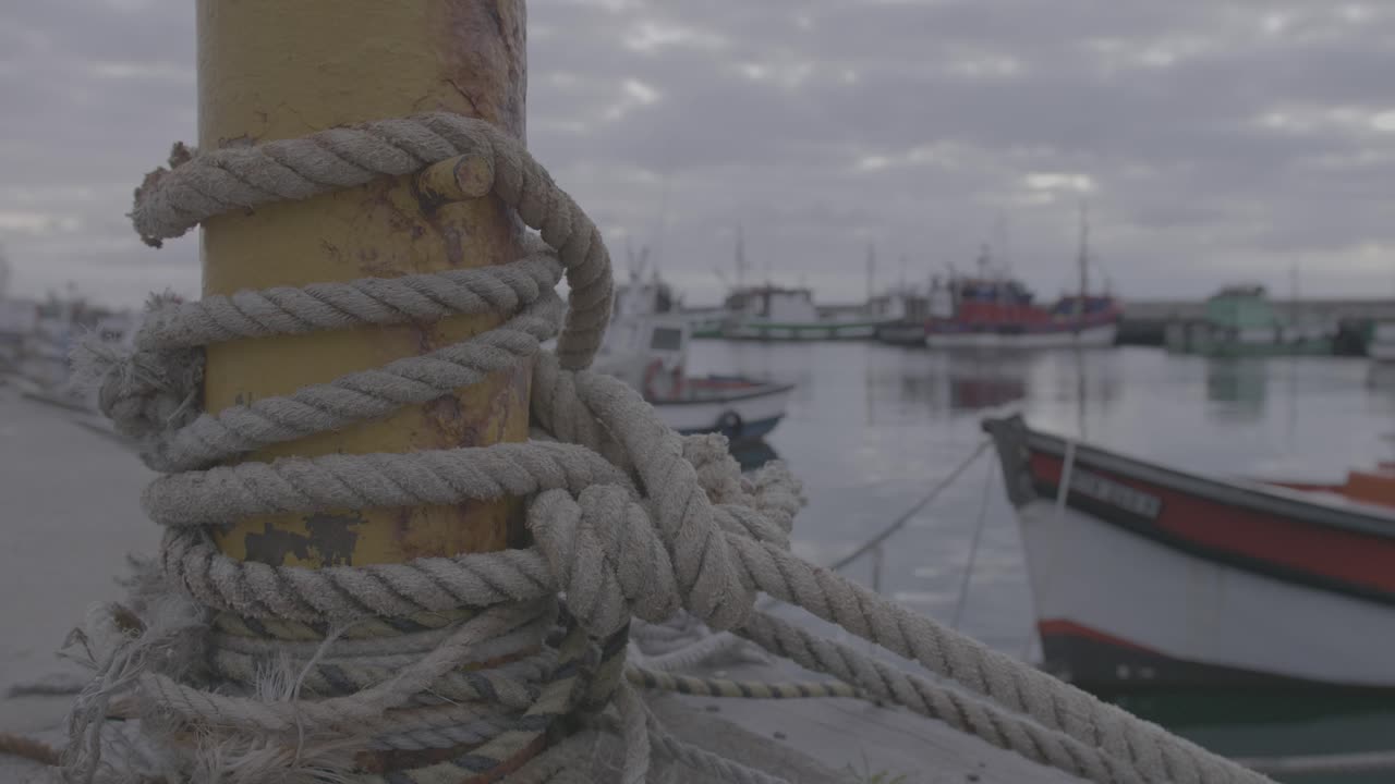 Rope holding a moored boat on Kalk Bay Harbour in Cape Town, South Africa