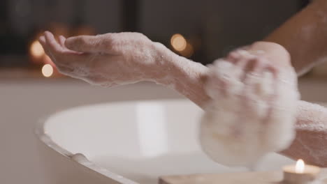 close up view of a woman taking a bath while rubbing her legs with soap 1