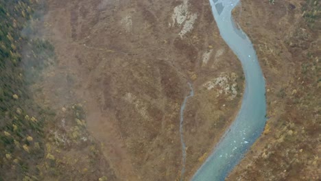 aerial view of a river winding through autumnal landscape