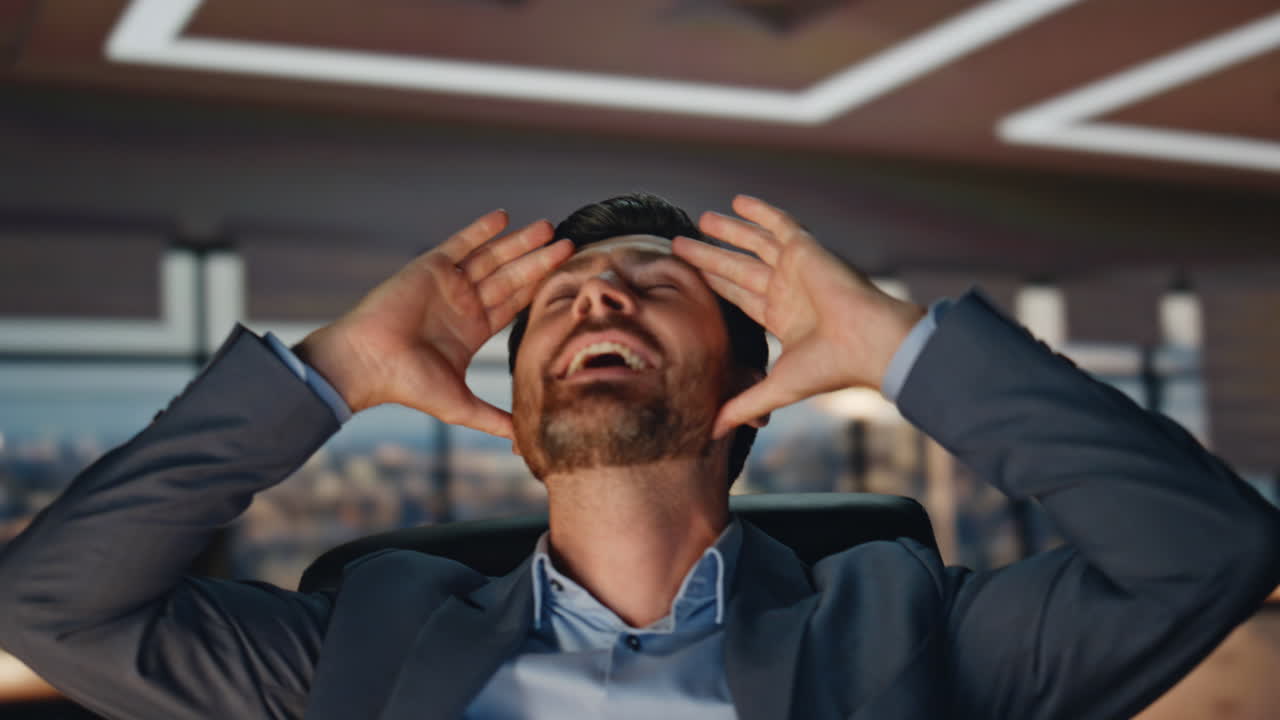 Man winner celebrating success in evening office closeup. Boss gesturing hands