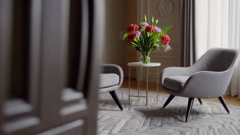 elegant living room with cozy armchair and flowers
