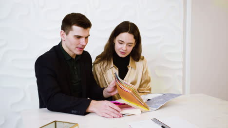 couple sitting in wedding planner office