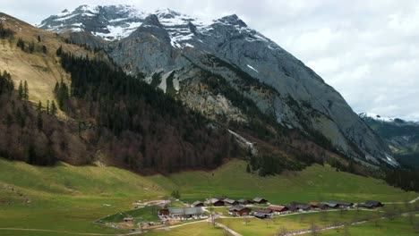 aerial drone flight at scenic ahornboden mountain valley above engtal village along the rissach river with fresh blue water in the bavarian austrian alps on a cloudy and sunny day