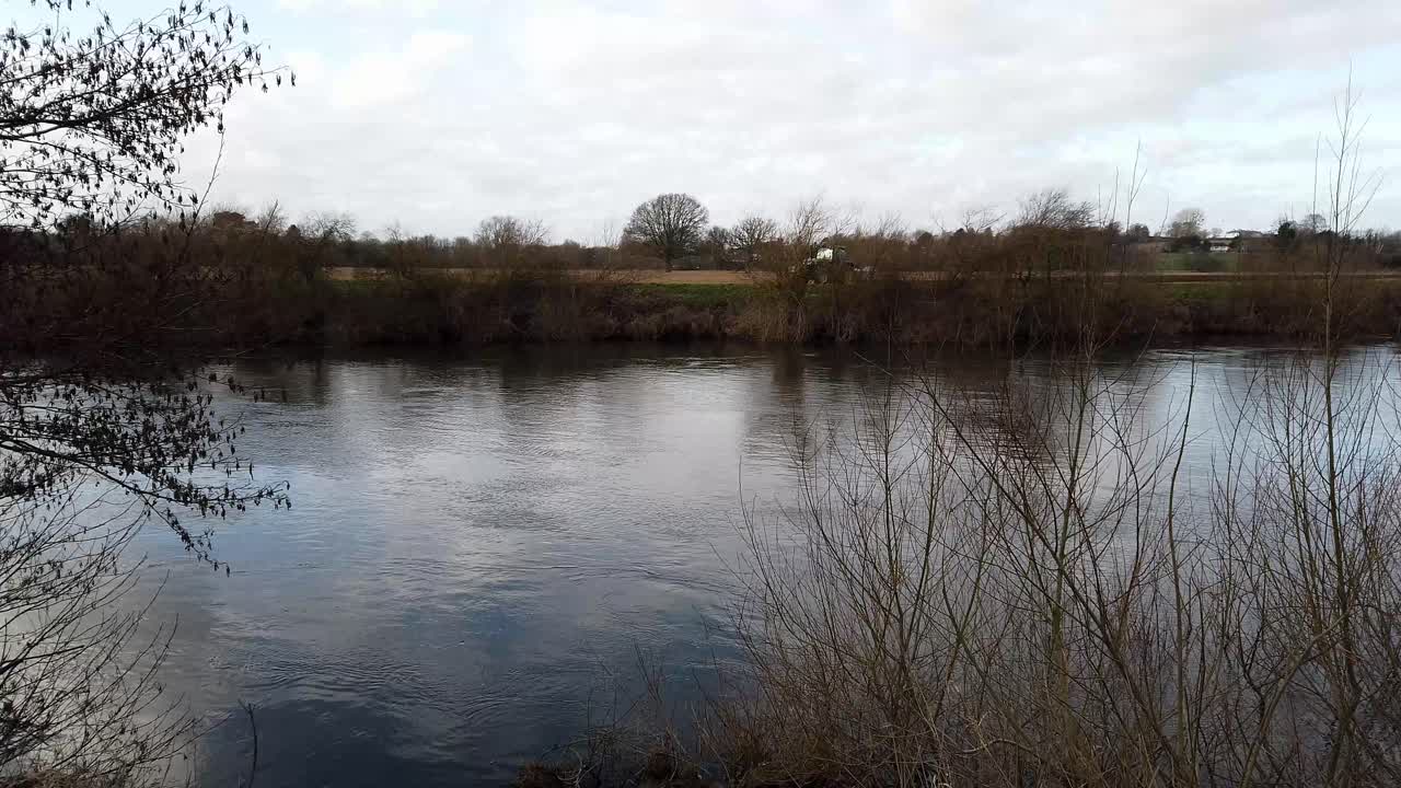 Ross on Wye, by river in early spring, with tractor ploughing