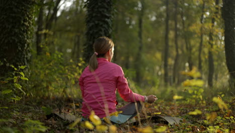 woman meditating in a peaceful forest