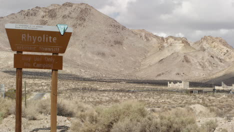 Timelapse-of-Rhyolite-sign,-Ghost-town-mining-entrance