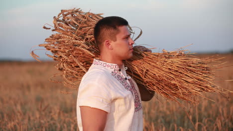 a man takes a sheaf of wheat