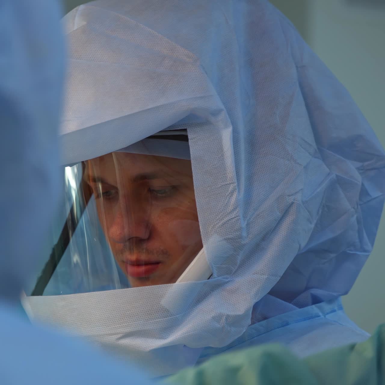 Portrait of doctor in safety suit. Medical specialist in protective uniform and hat working in intensive care unit. Virus concept.