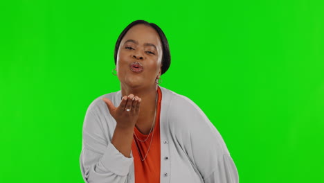 Black-woman,-blow-kiss-and-green-screen-in-studio