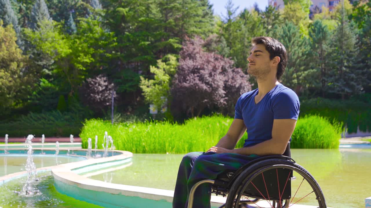 Young man in wheelchair outdoors.