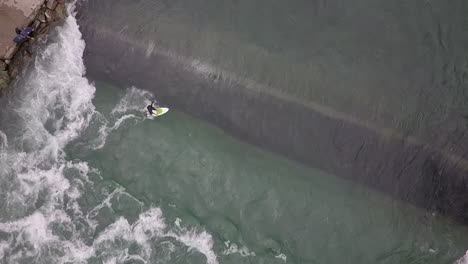 aerial view as swiss surfer shreds small standing wave on reuss river