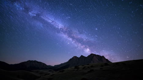 milky way and star trails over mountains at night