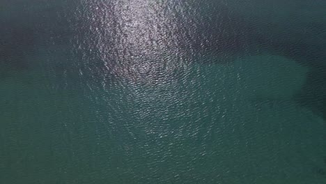 4k tilt up clip of the ocean over a peninsula on the tropical beach of epanomi, halkidiki, greece
