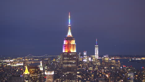 empire state building at night with colorful lights