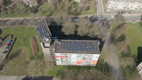 aerial of solar panels on large apartment building rooftop
