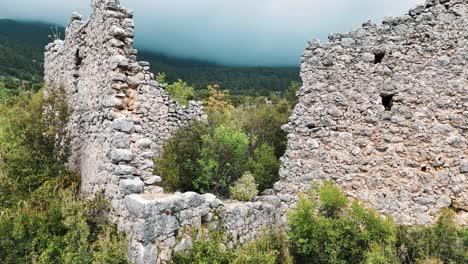 Aerial-View-of-the-Ruins-of-the-Ancient-Roman-Kadrema-Castle-Located-in-the-Gedelme-Village-and-Mountain-Ridge-on-Background